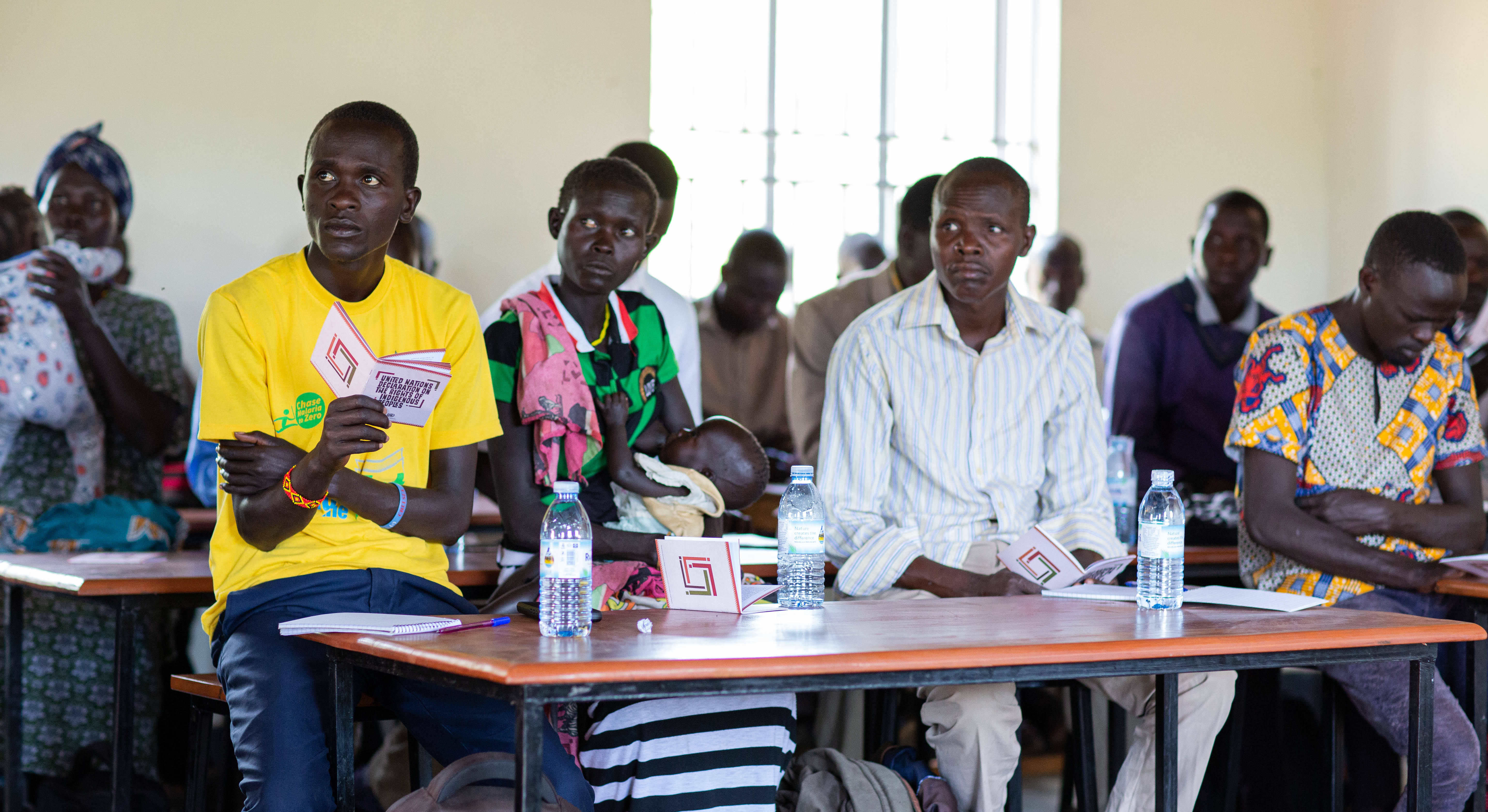 Participants at a community workshop on the rights and wellbeing of indigenous peoples in Kamion, Uganda with representatives of the Ik people